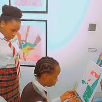 Students studying paintings on an art gallery visit