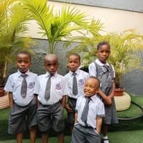 Young Joef Dynamic pupils in uniform posing in the school garden